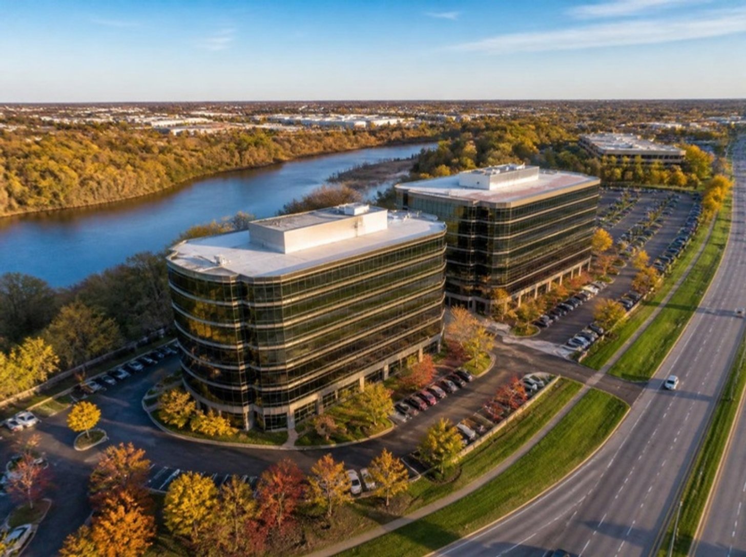 Mid-rise glass office buildings along a river in Buffalo Grove, IL, Buffalo Grove office space guide for tenants | Tenant Advisors