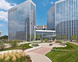 Twin glass office towers with landscaped plaza in the O'Hare market